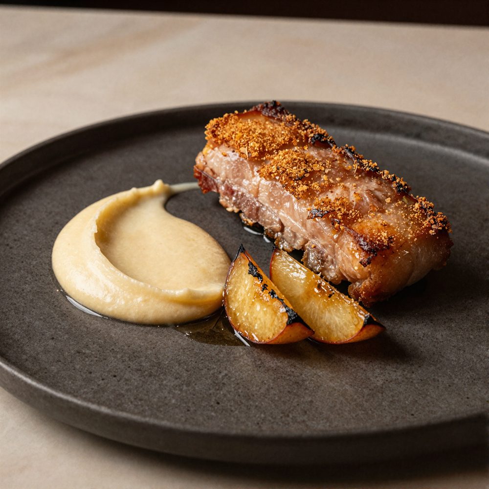 Crispy pork belly with apple purée, charred apple and cider jus