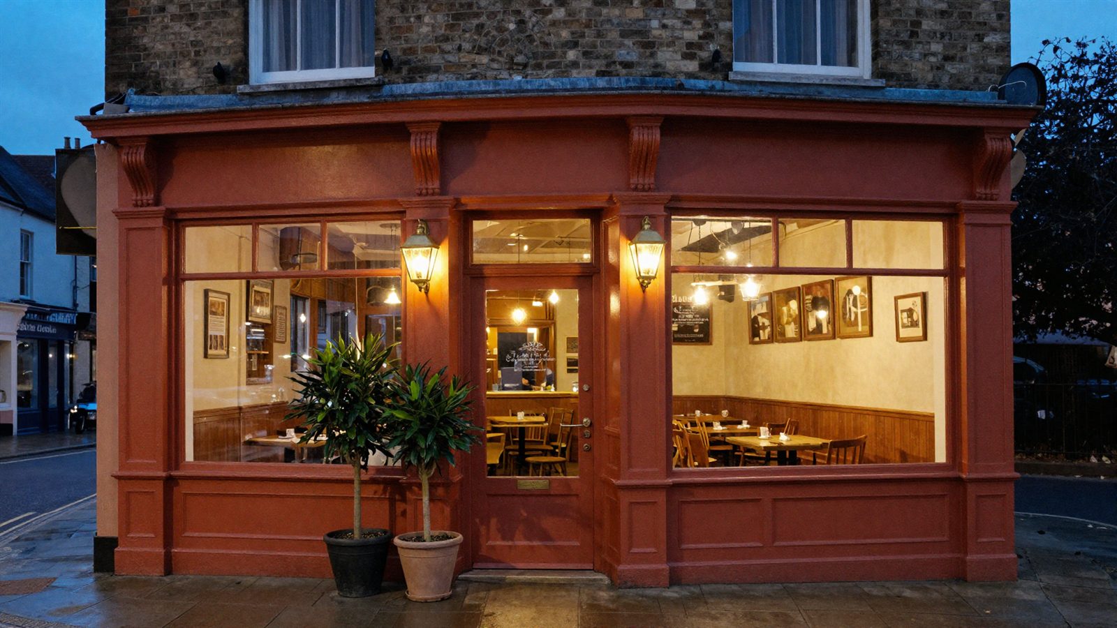 The terracotta shopfront of Vine & Fig lit up at dusk