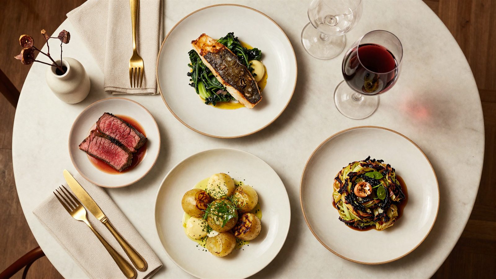 An overhead spread of dishes on a marble table at Vine & Fig